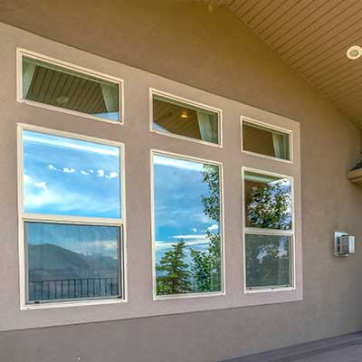 Residential front porch with three modern windows on the front wall