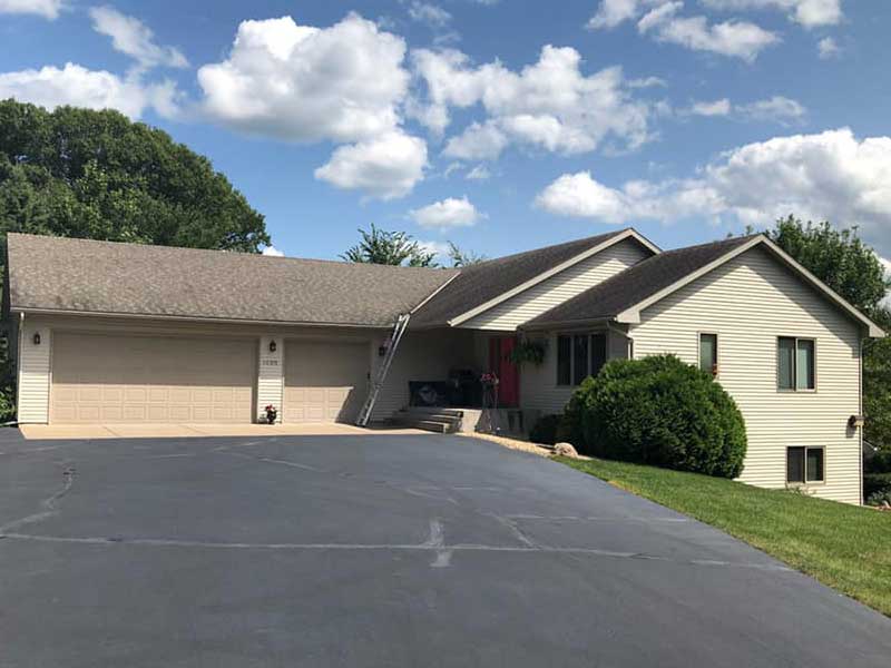 Home exterior with new light beige siding installed by Clear Point Construction, Inc.